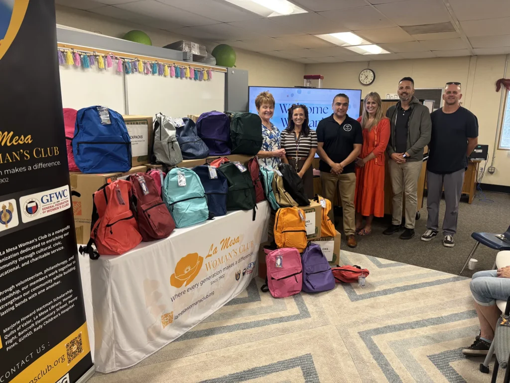 La Mesa Woman's Club members and Bancroft Elementary representatives celebrate the Back-to-School Backpack donation.